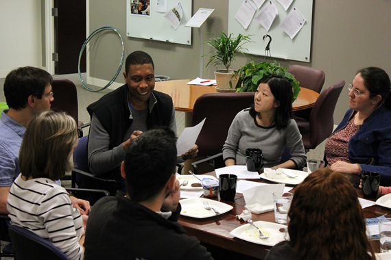 Researchers around a table discussion ideas