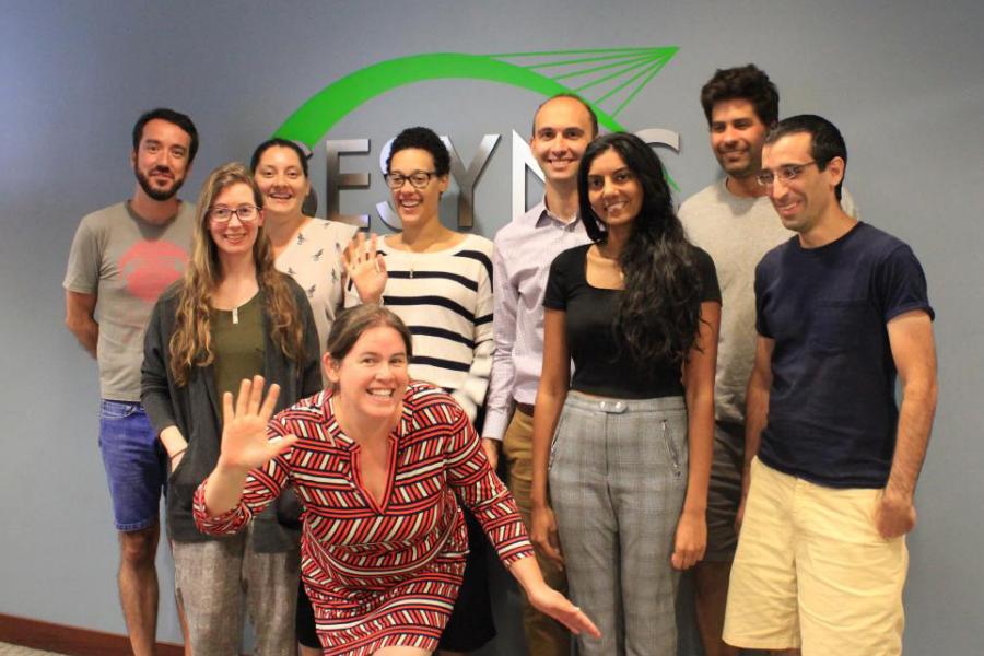 SESYNC postdocs gathered together in front of the SESYNC sign