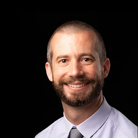 A headshot of Dennis Guignet