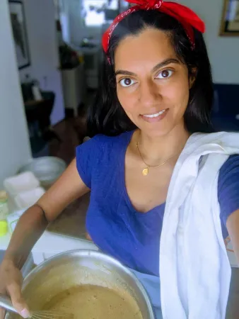 A photo of Varsha Vijay holding a bowl with batter