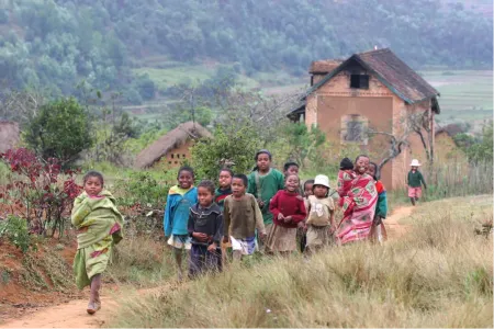 A group of children walking outside along a path