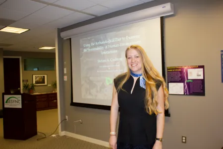  Stefani Crabtree posed in front of a projector screen