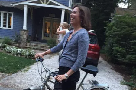 A woman posing with a bicycle