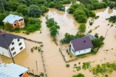 An aerial view of homes surrounded by flood waters